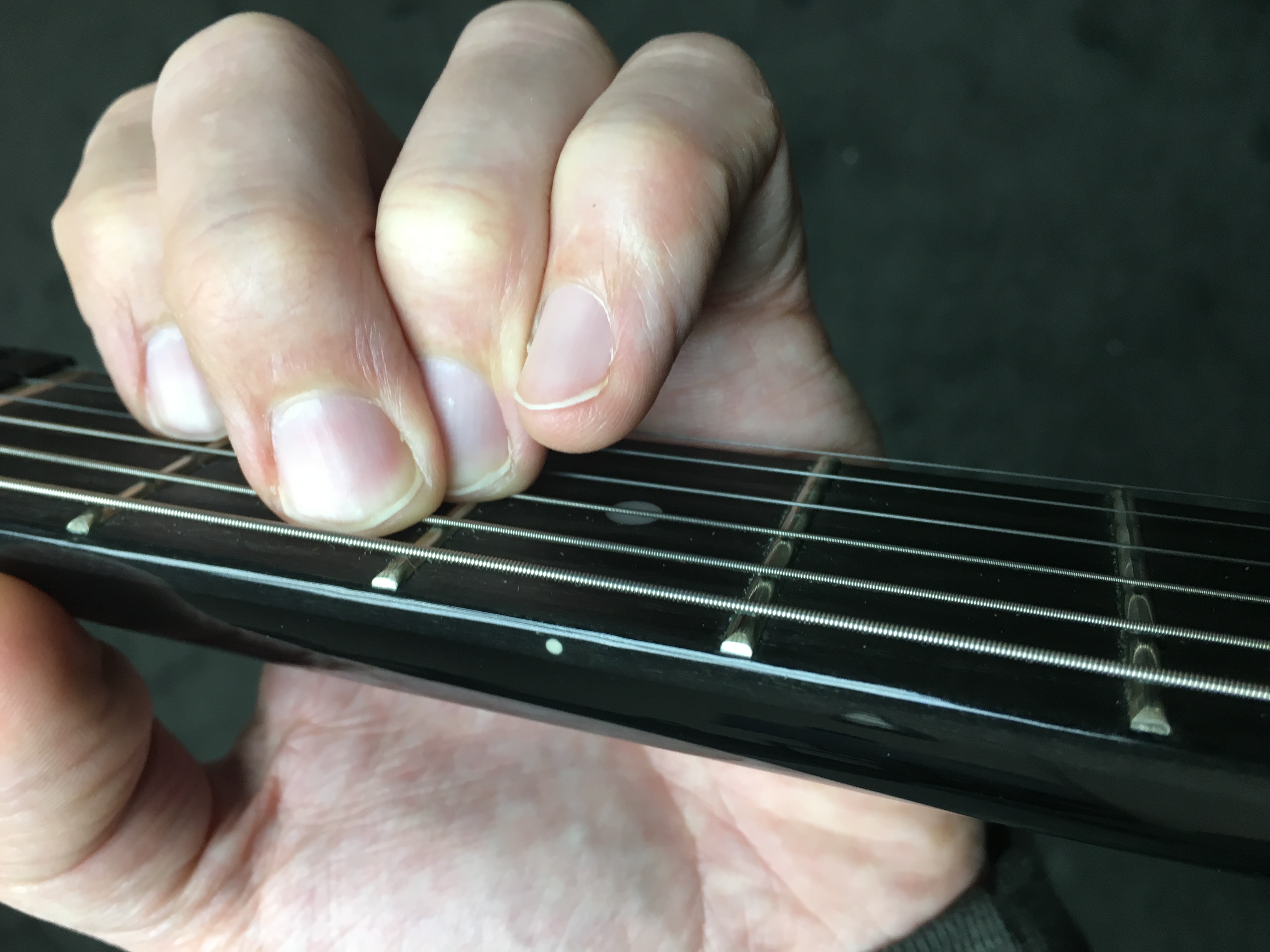 Play up against the frets